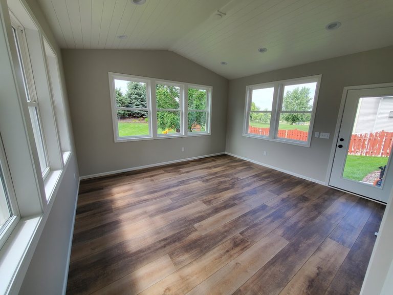 Sunroom addition with hardwood floors and wraparound windows — MDR Design-Build-Remodel