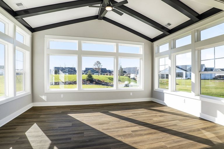 Sunroom addition with a vaulted beam ceiling and wood floors — MDR Design-Build-Remodel