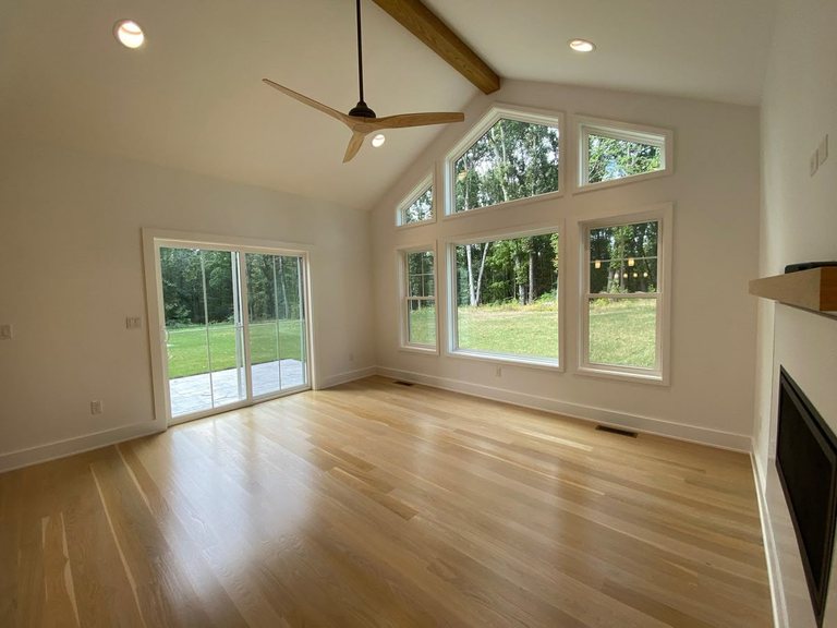 Bright vaulted addition with a fireplace and sliding patio doors — MDR Design-Build-Remodel