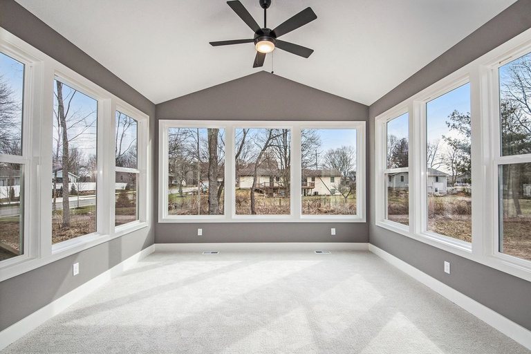 Sunroom addition with carpet, a vaulted ceiling, and a ceiling fan — MDR Design-Build-Remodel