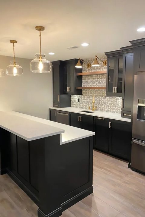 Basement wet bar with dark cabinetry and quartz counters — MDR Design-Build-Remodel