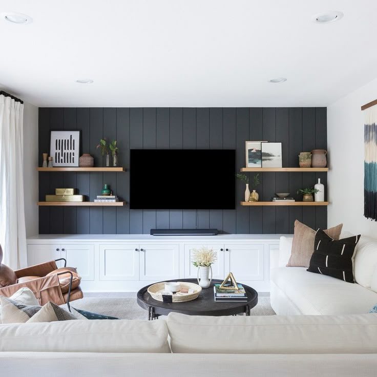 Basement living area with a dark shiplap media wall and white sectional — MDR Design-Build-Remodel