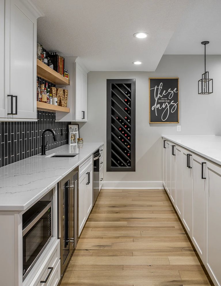 Basement kitchenette with white cabinets and a wine display — MDR Design-Build-Remodel