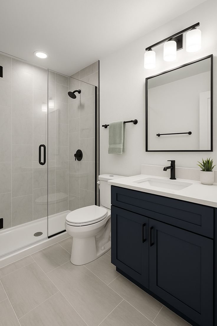 Bathroom with a navy vanity, glass walk-in shower, and black fixtures — MDR Design-Build-Remodel