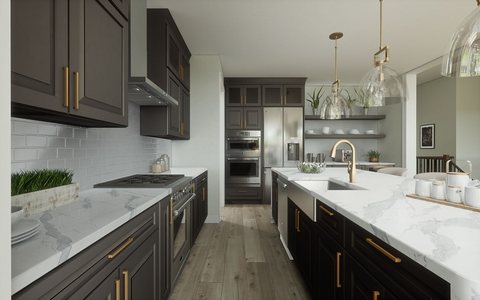 Modern kitchen with dark cabinets, brass hardware, and a marble waterfall island — MDR Design-Build-Remodel