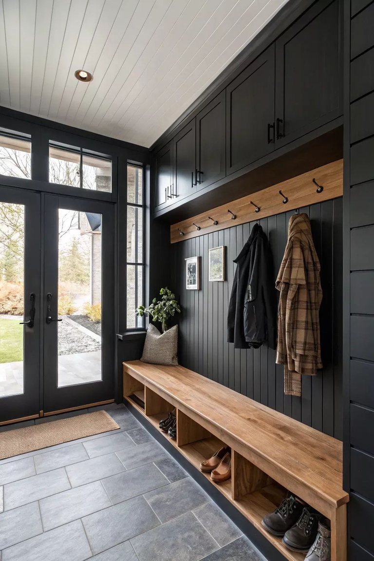 Mudroom with dark built-in lockers and a wood bench — MDR Design-Build-Remodel