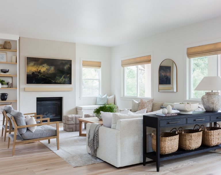 Bright, furnished living room with a fireplace in a whole-home remodel — MDR Design-Build-Remodel